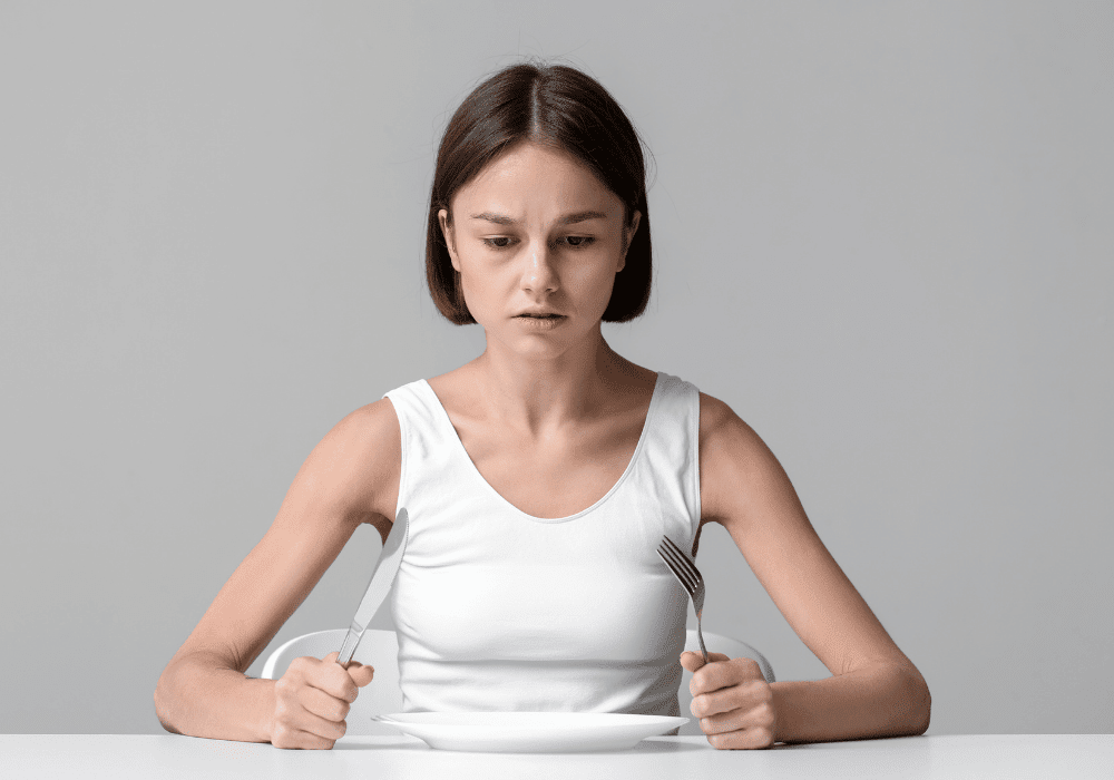 A lady anxious and scared of eating due to eating disorder identity and on her way to recovery journey toward authentic self